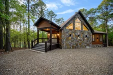 Hygge Hideaway cabin fire pit area surrounded by pine trees